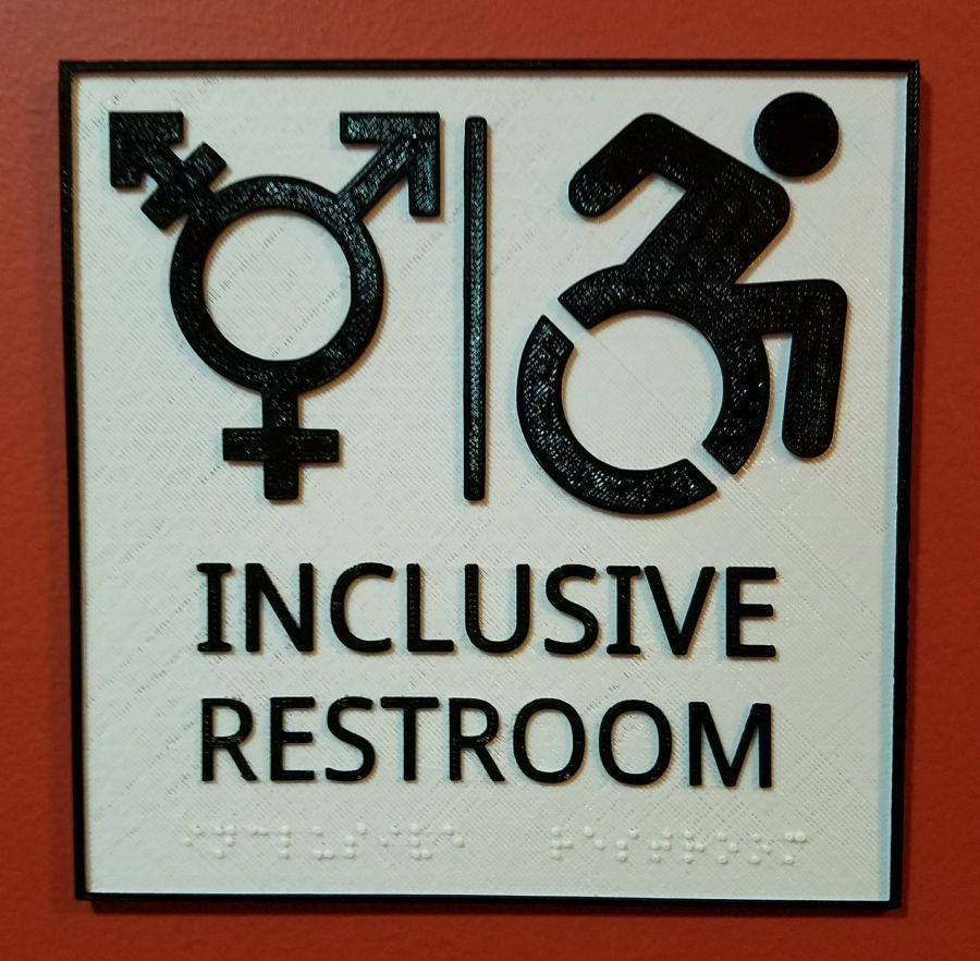 W tym znak toalety z pismem Braille&#39;a